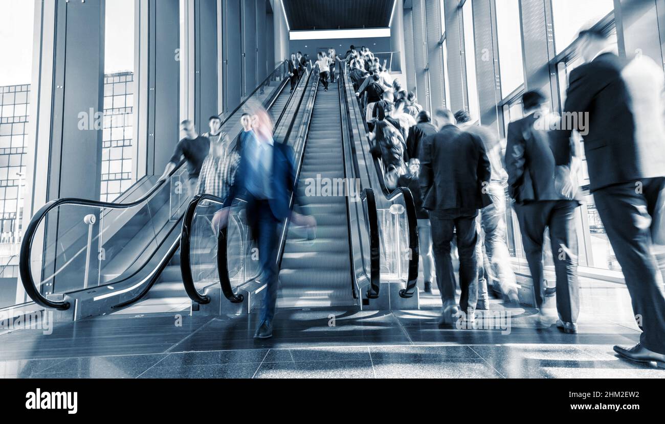 Motion Blurred business on a escalator Stock Photo
