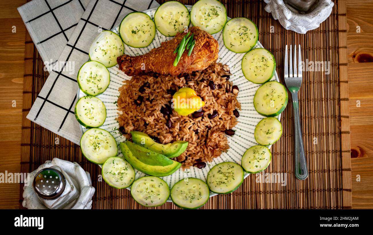 Close-up shot of the brown rice with a a grilled chicken and vegetables on a plate Stock Photo