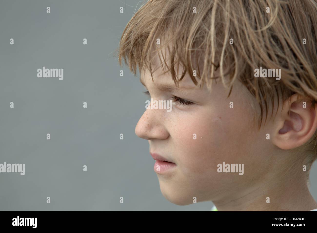 Close-up portrait of sad and thoughtful freckled teen boy looking away ...