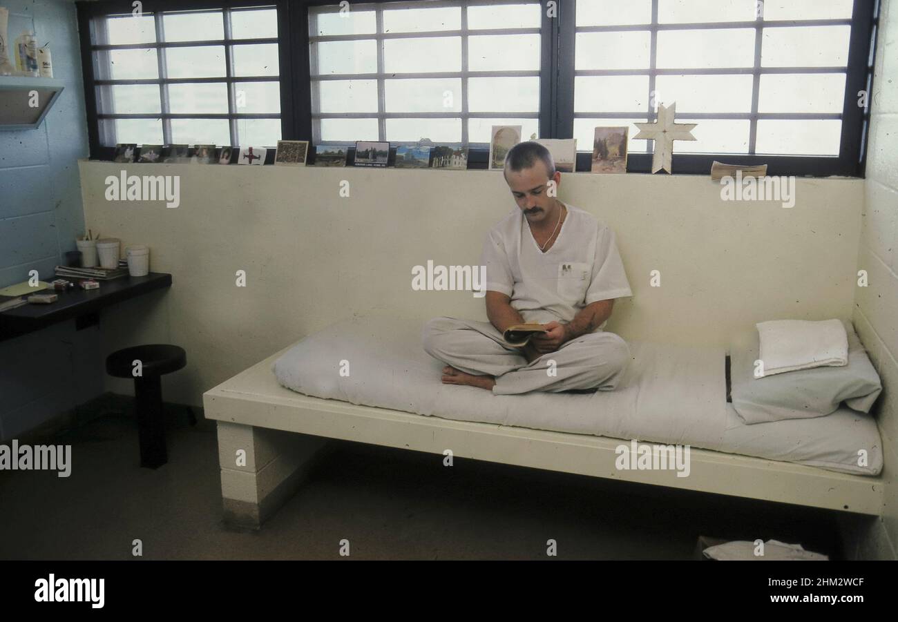 Austin, Texas USA, 1987: Prisoner in solitary confinement sitting on his sleeping cot at the Travis County Jail.  MR RE-0154   ©Bob Daemmrich Stock Photo