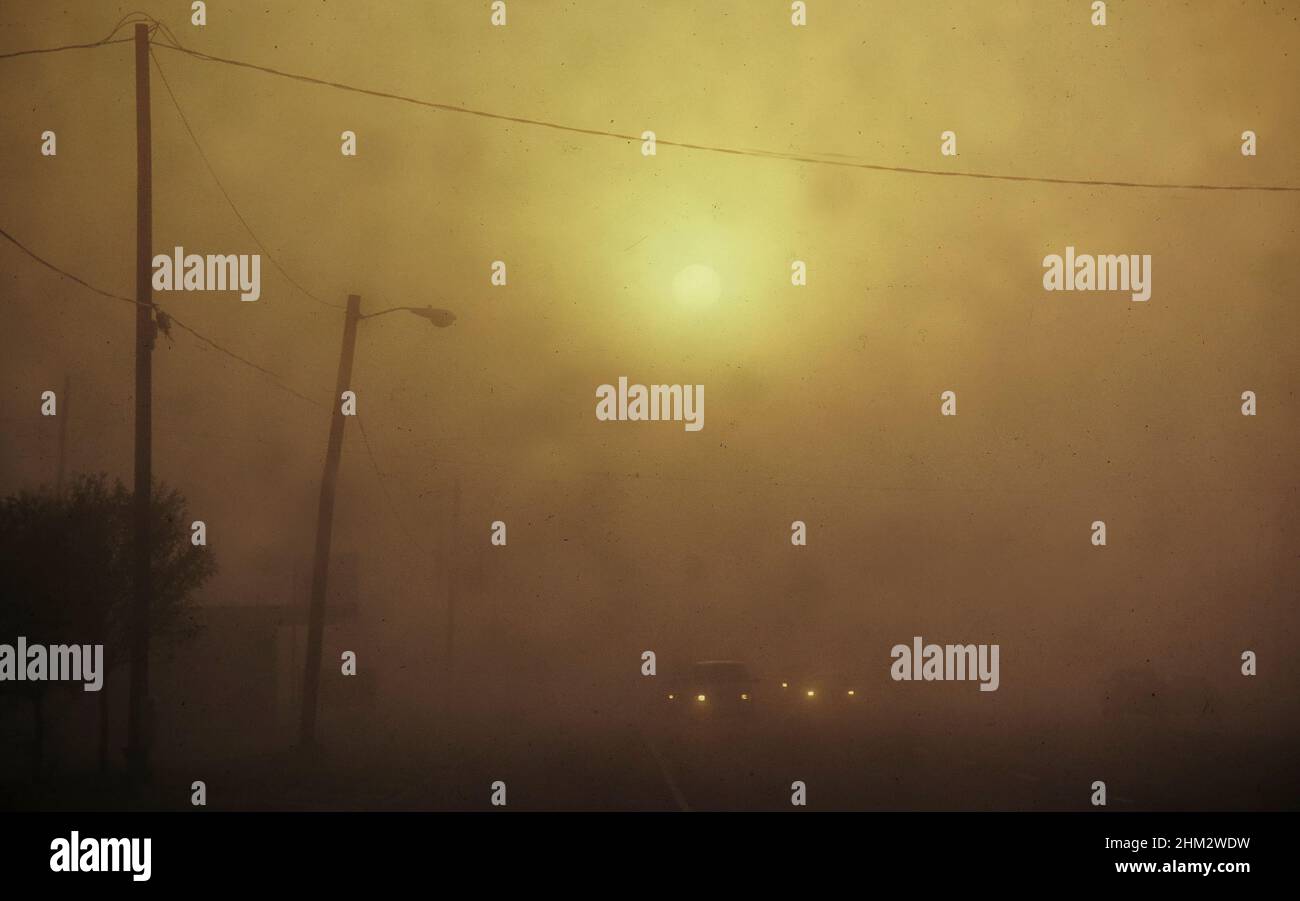 Harlingen Texas USA car headlights and rising sun are