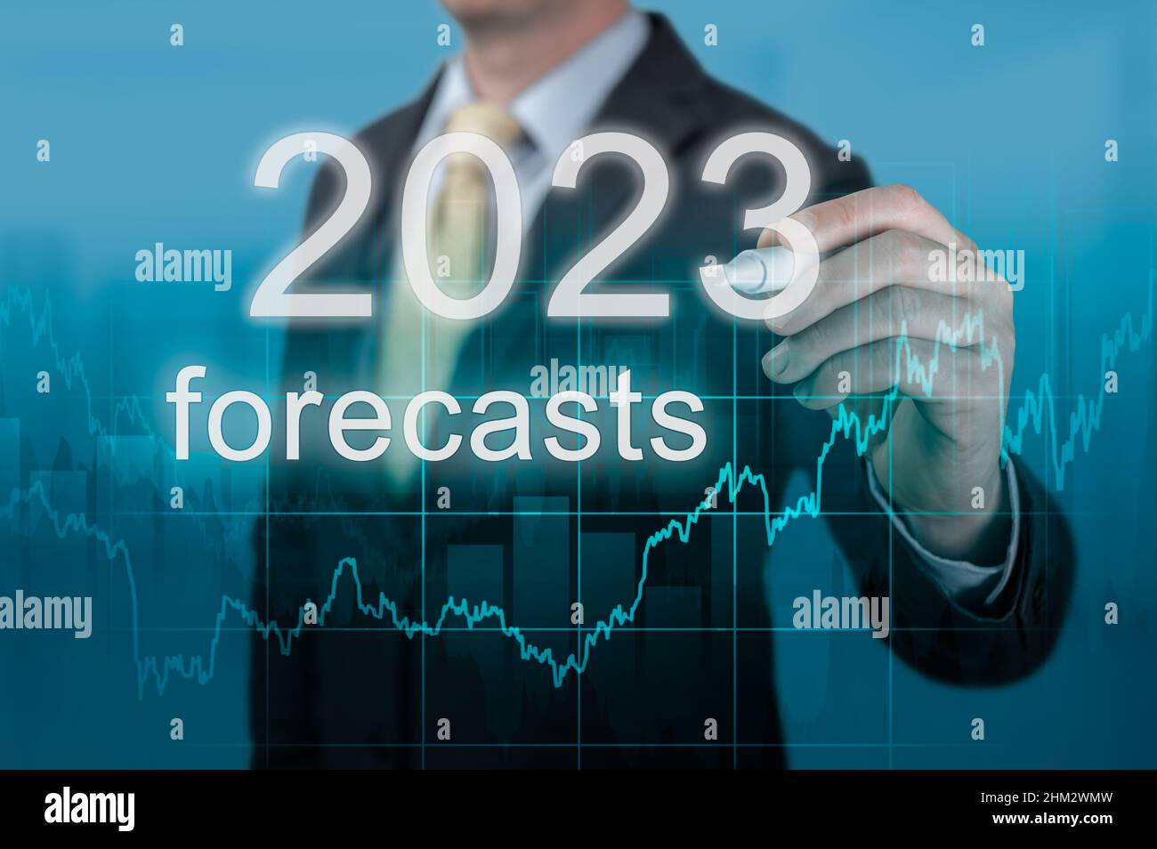 Economic forecasts for 2023. businessman writes forecasts for 2023 on virtual screen. Post covid