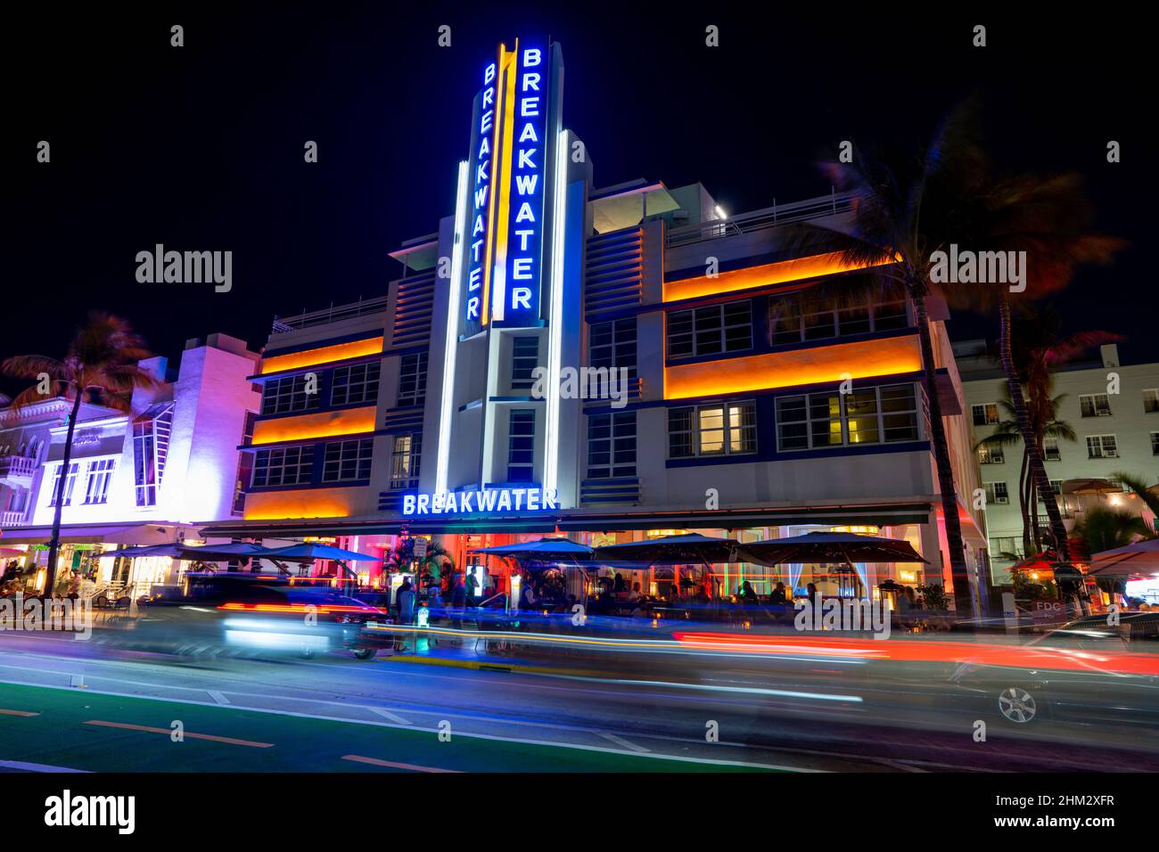 Miami Beach, FL, USA - February 2, 2022: Night photo of the Breakwater hotel with car light trails passing in front Stock Photo