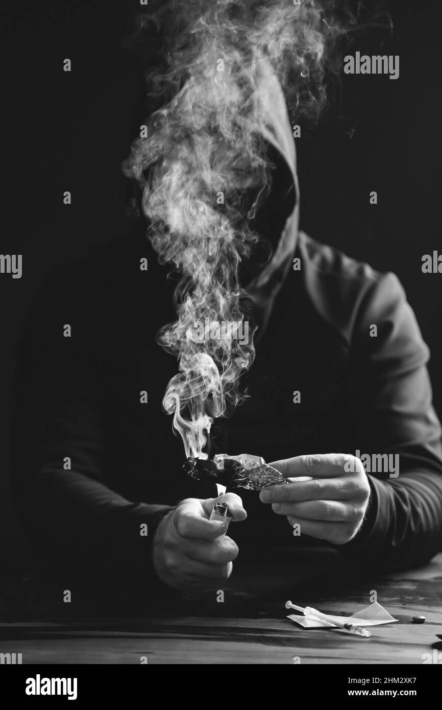 Addict/junkie man preparing drugs. The concept of crime and drug addiction Stock Photo Alamy