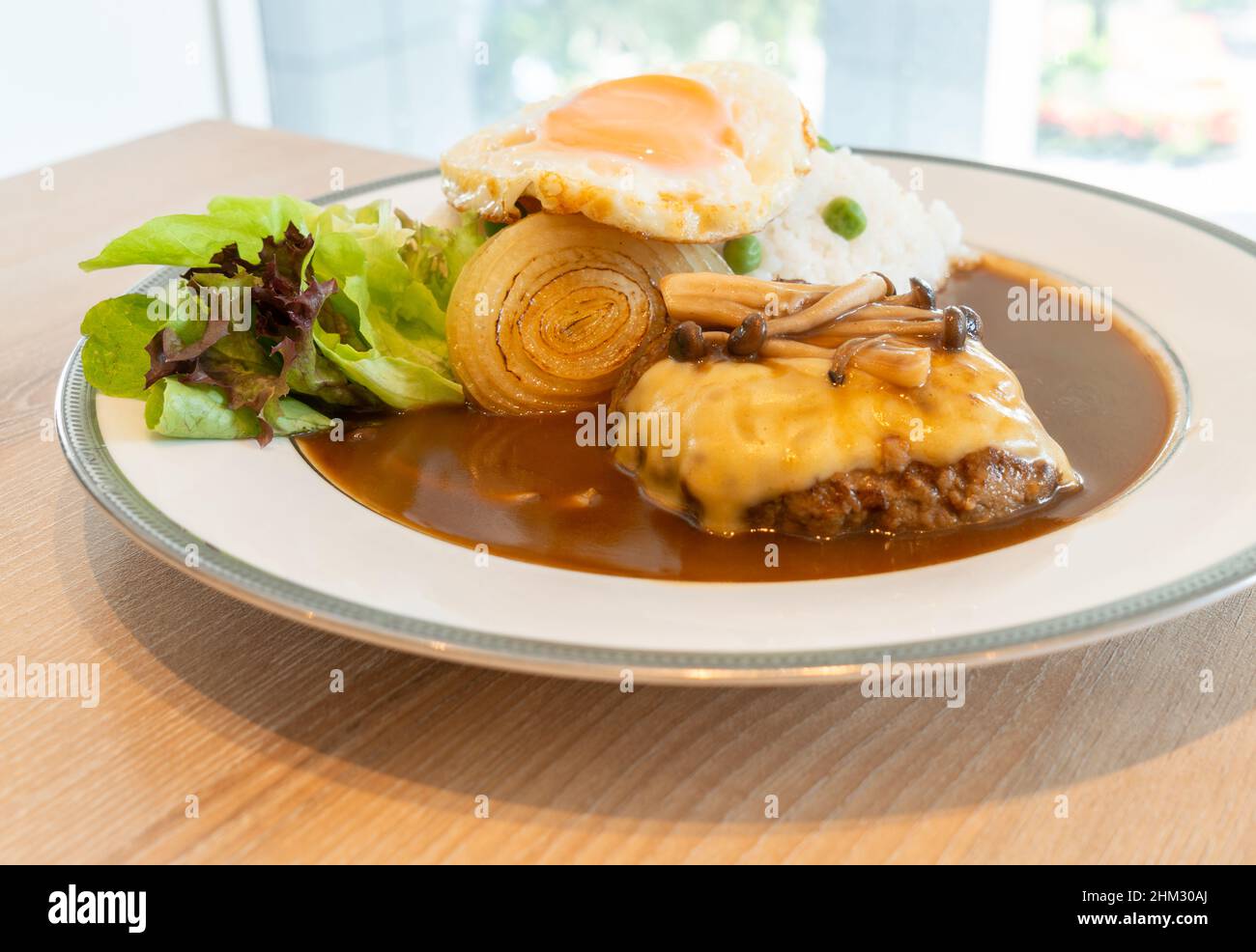 Close up Japanese Burger and curry with white rice, topped with cheese