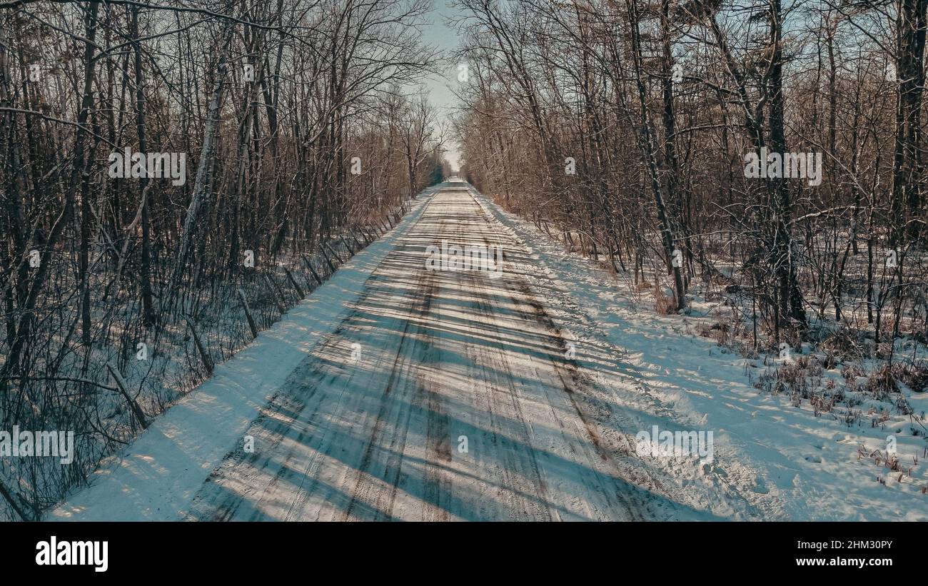 Empty dirt road covered with snow hi-res stock photography and images ...