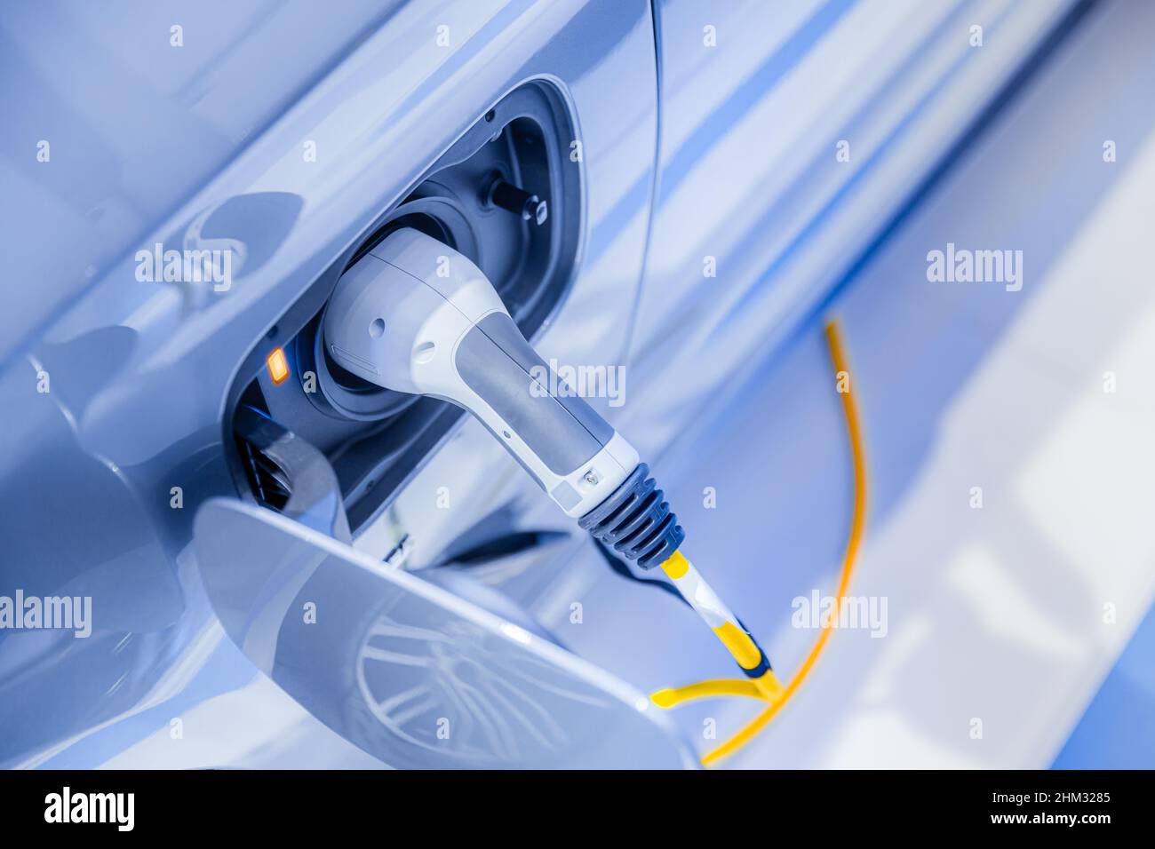 electricity car or EV car plug in power charging at power station future driving concept Stock Photo