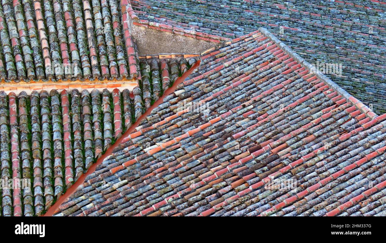 Closeup of old dirty clay roof tiles in the daylight Stock Photo