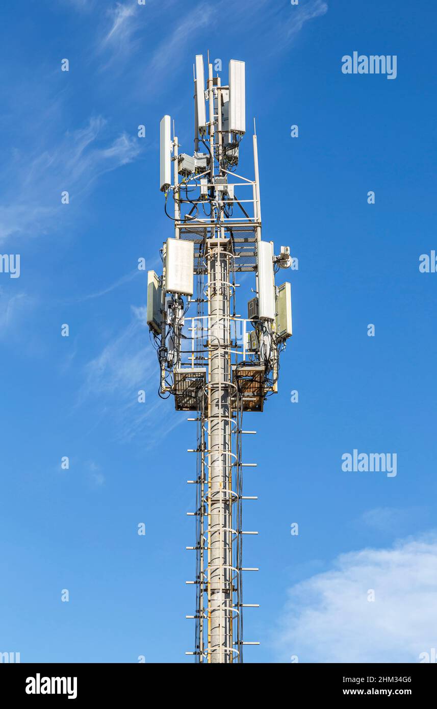 Radio communications tower against a blue sky Stock Photo