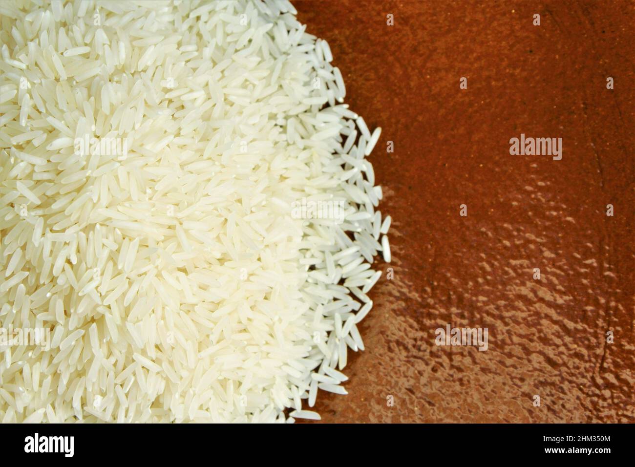 Top view of white rice on clay plate. photo isolate copy space Stock Photo