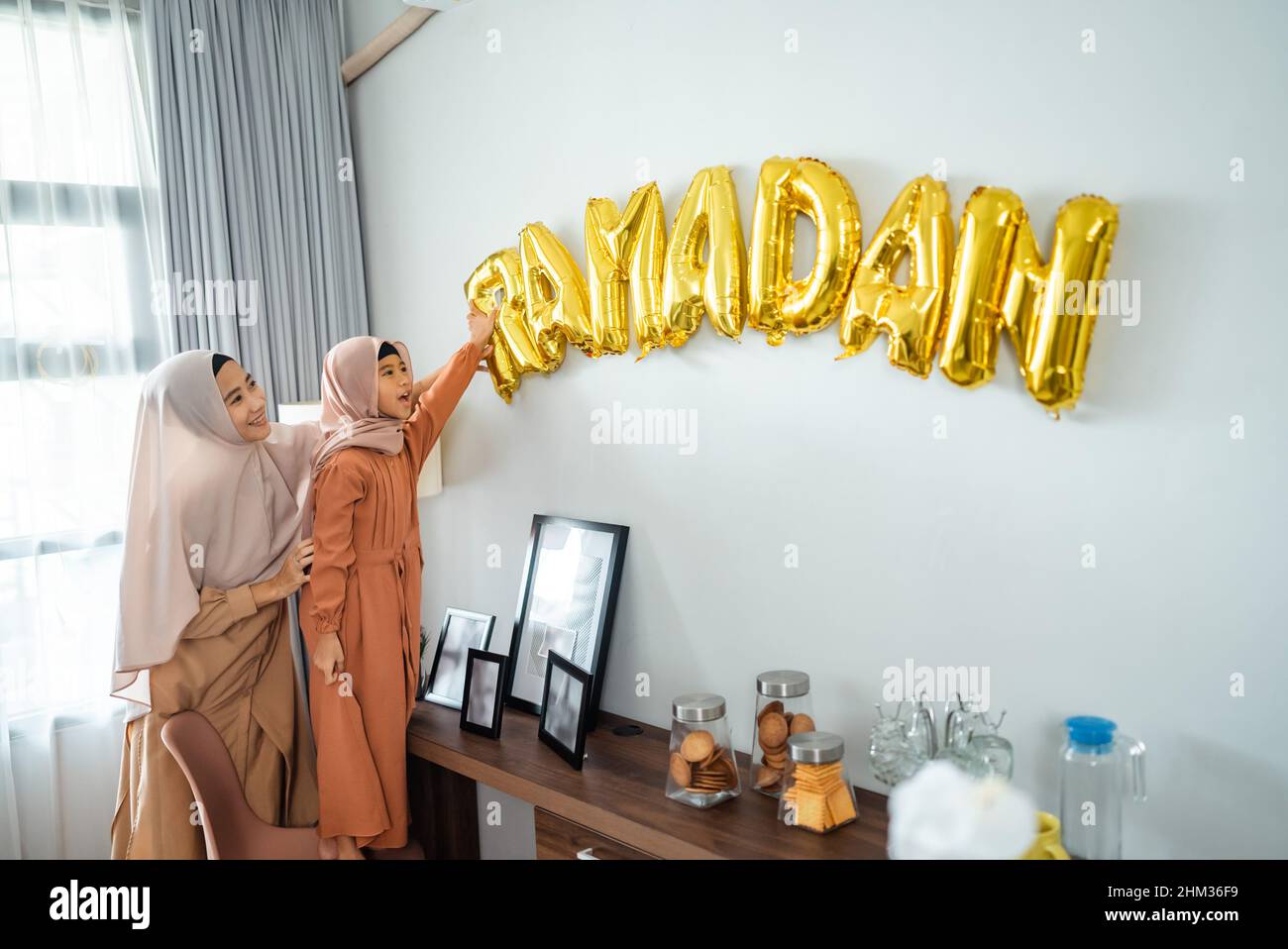 mother and daughter Muslim decorating house with ramadan Stock Photo
