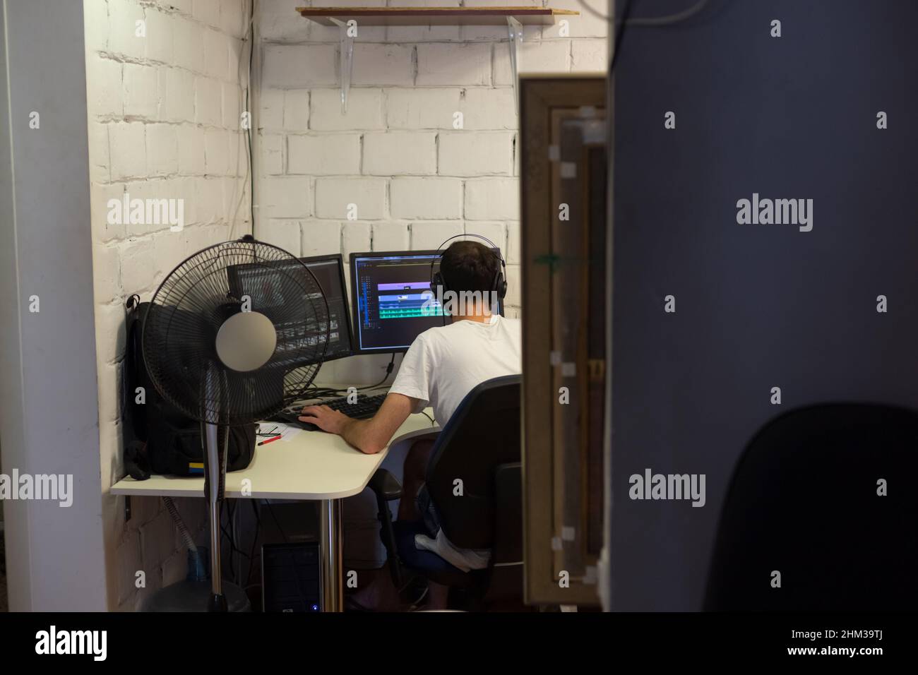 Back view of creative filmmaker working on a movie on laptop. Editing director editing a TV program Stock Photo