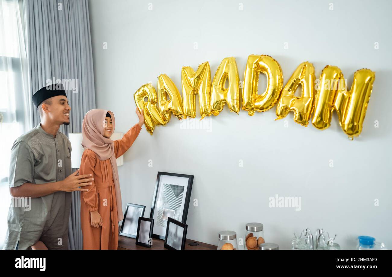 father and daughter Muslim decorating house with ramadan Stock Photo