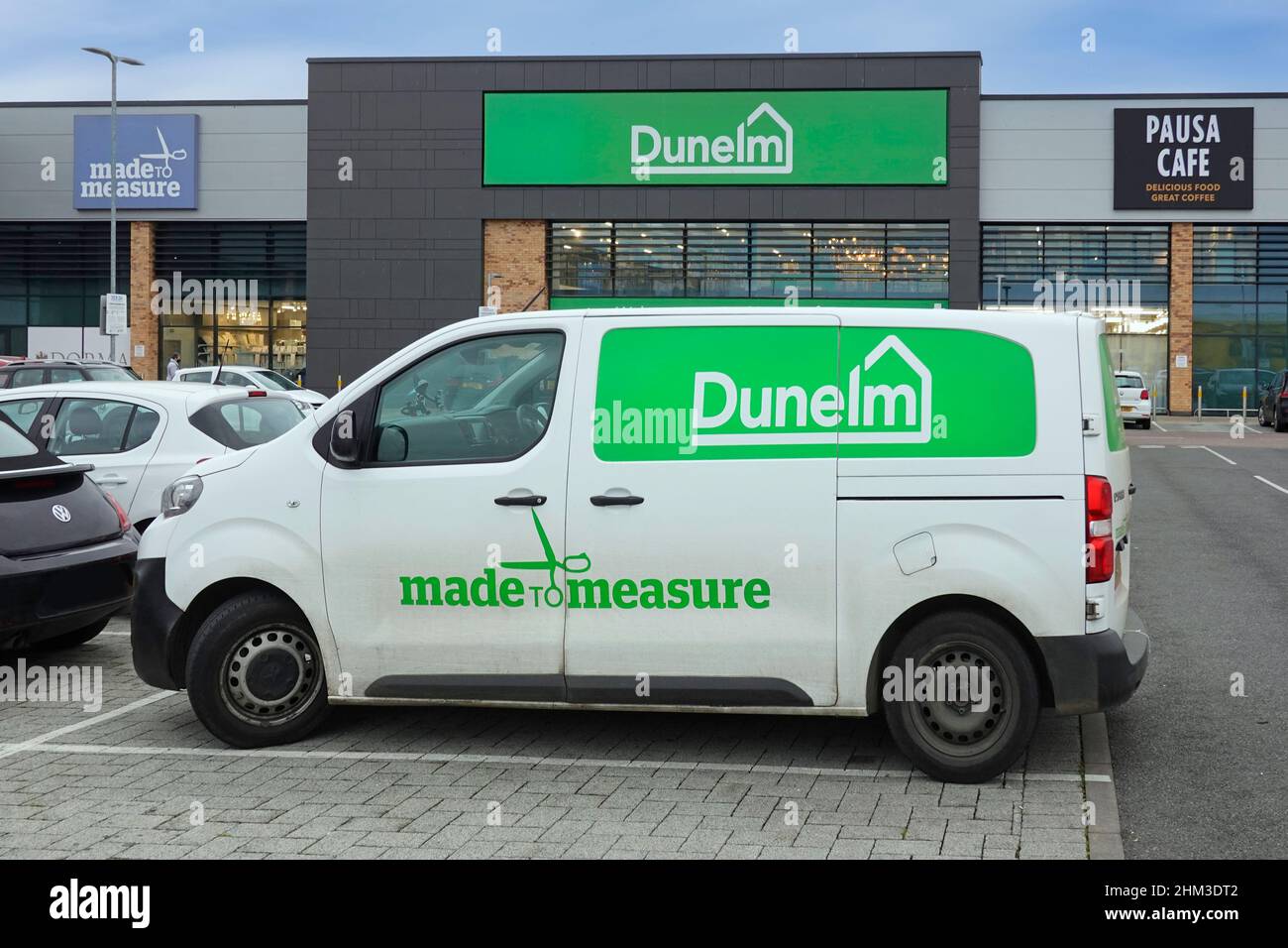 Dunelm logo brand for a made to measure curtain service via Peugeot Expert white van in retail park car park outside shop units Chelmsford England UK Stock Photo