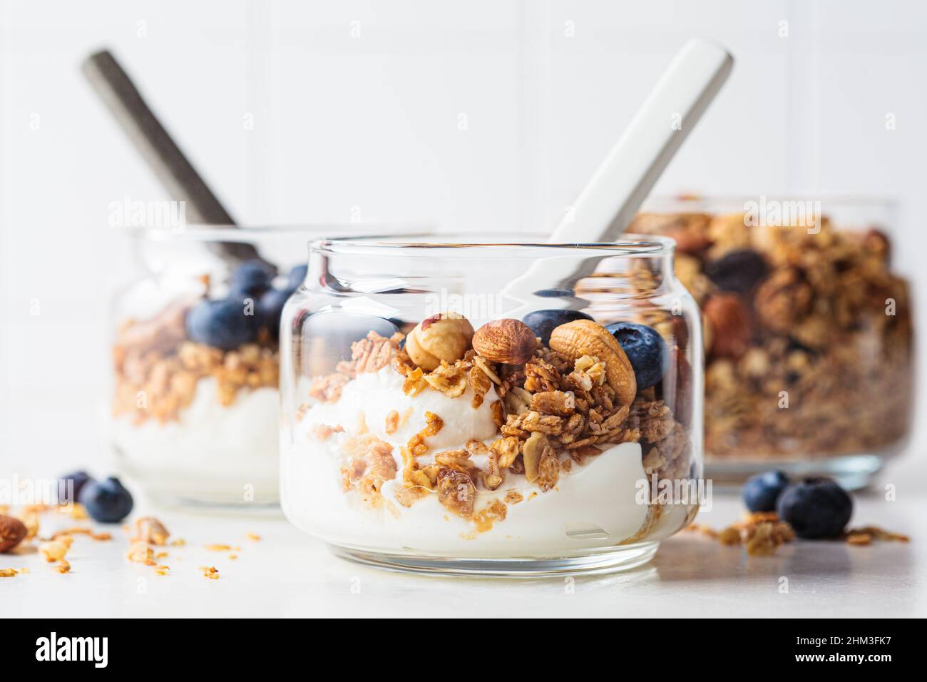 Granola with nuts, yogurt and berries in a jar. Breakfast parfait with muesli, yoghurt and
