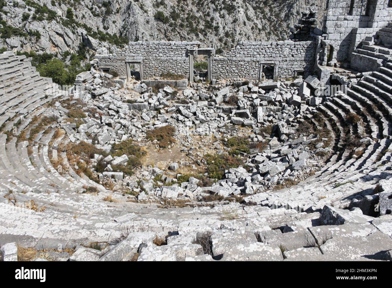 Termessos, Antalya, Turkey - September 09 2012: View of ancient theater and mountain against the sky Stock Photo