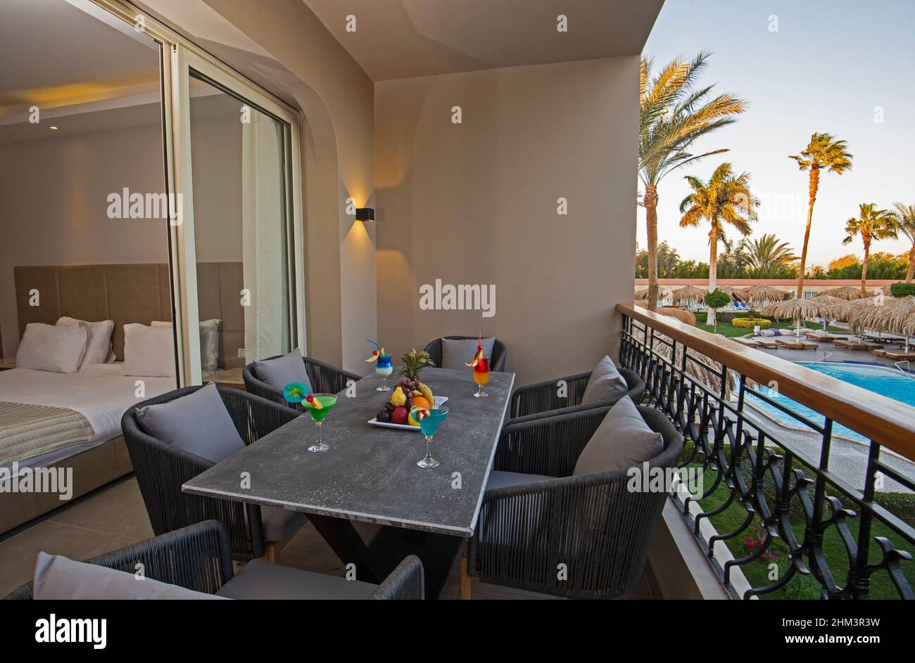 Patio terrace area at luxury tropical hotel resort double room by swimming pool Stock Photo