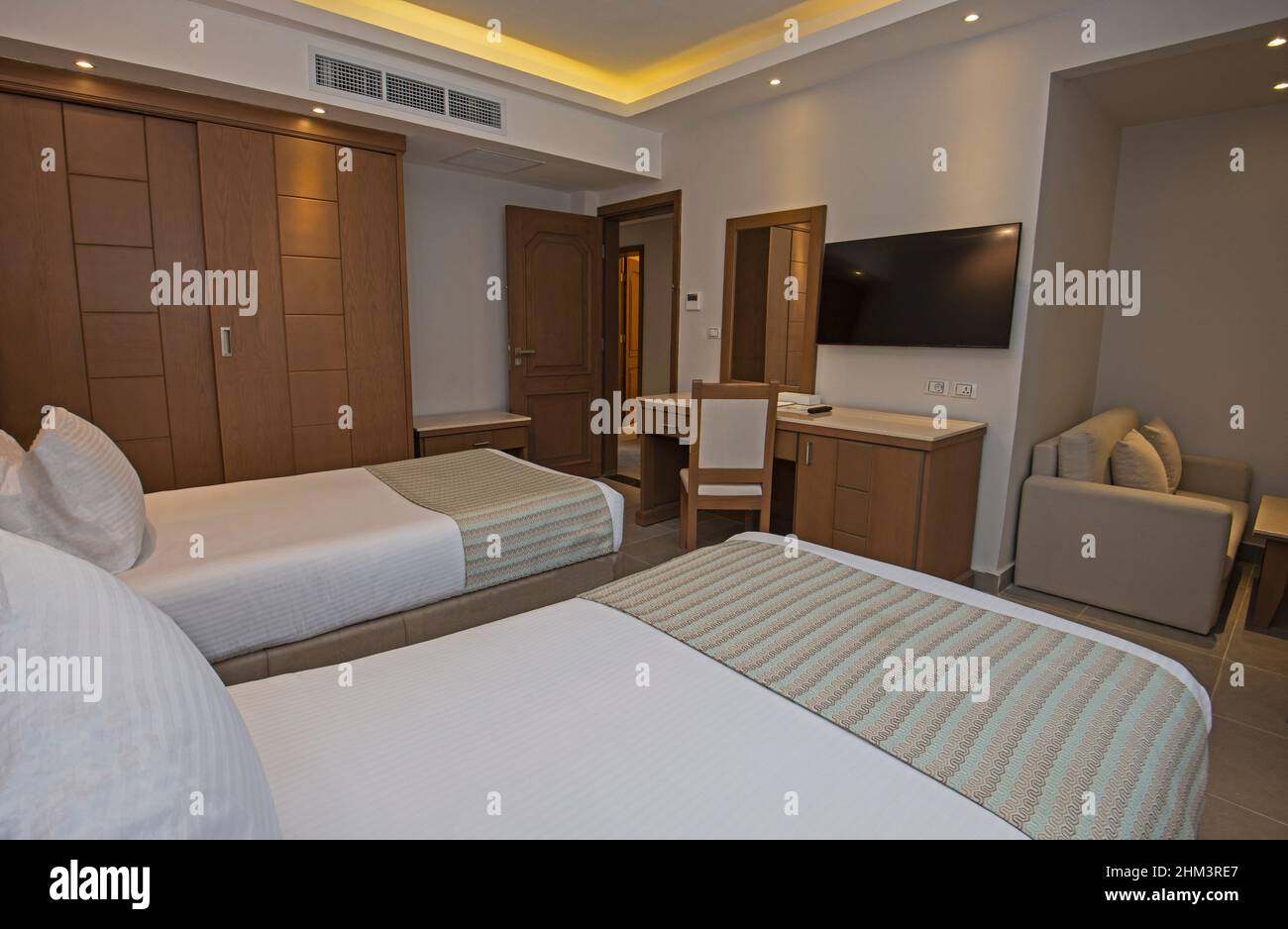 Twin beds in suite of a luxury hotel room with modern interior ...