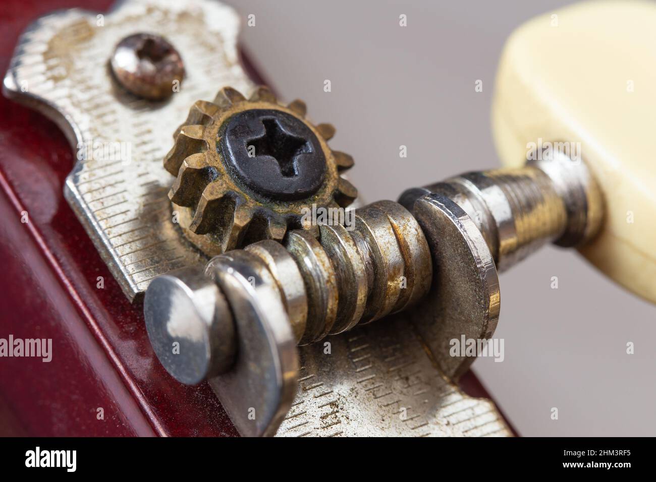 Old tuning peg of a classical guitar. Macro photography. Stock Photo