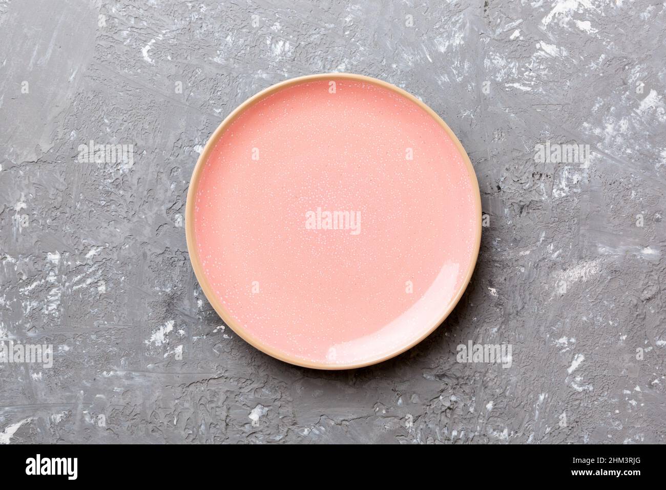 Top view of empty pink plate on cement background. Empty space for your ...