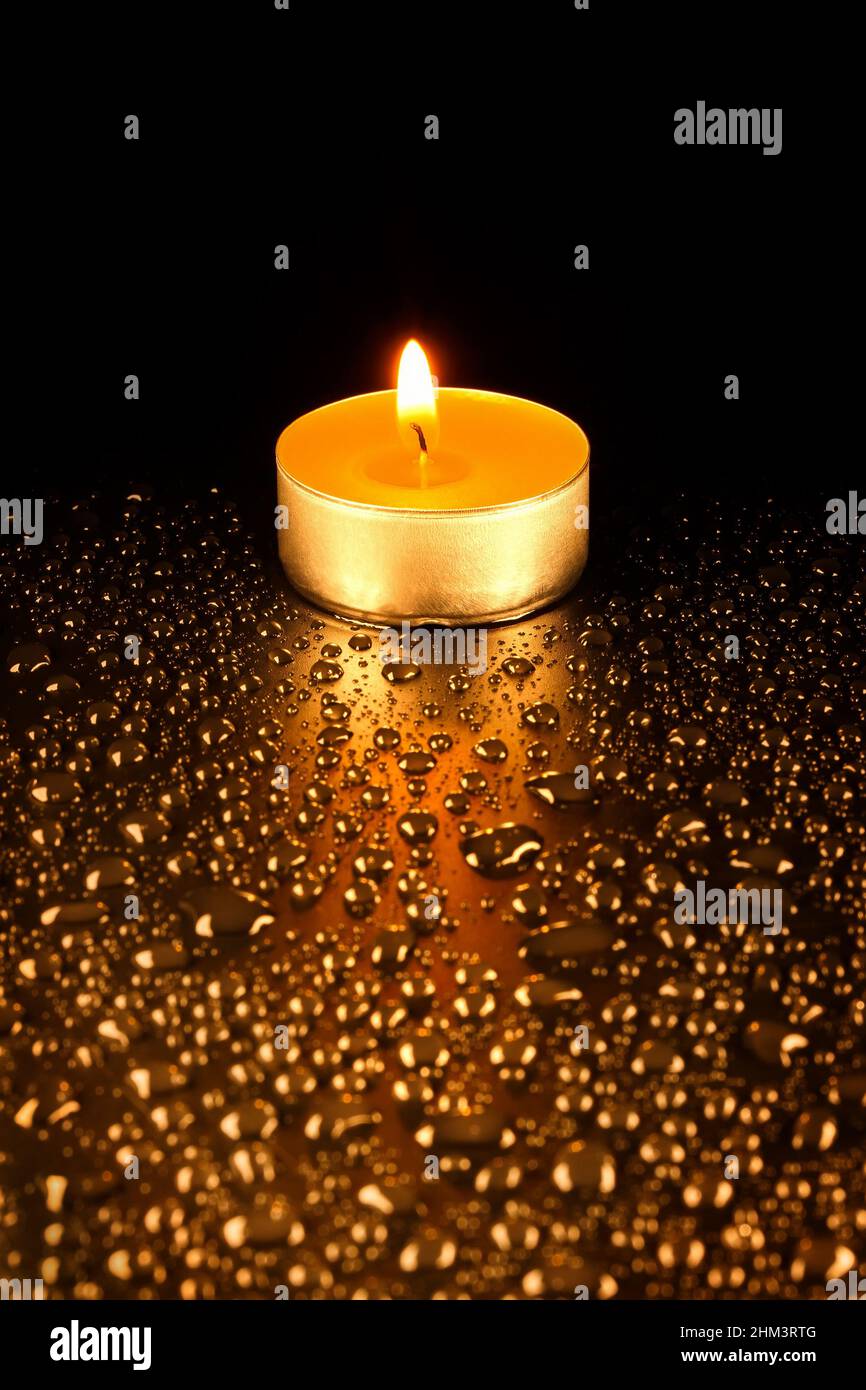 https://c8.alamy.com/comp/2HM3RTG/wax-candle-on-a-dark-background-surrounded-by-water-drops-blurred-foreground-2HM3RTG.jpg