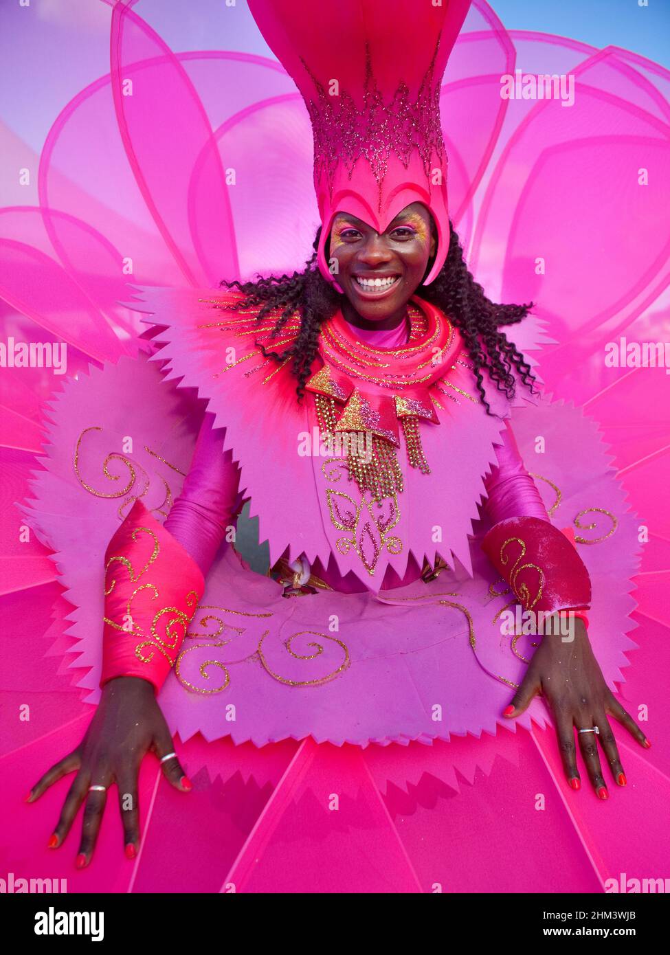 Vividly dressed female dancer from the Notting Hill contingent performing at the Seychelles Carnival. Stock Photo