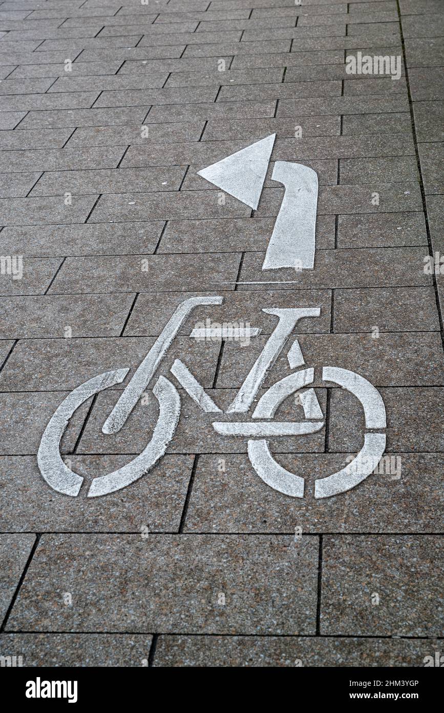 Bicycle marking on the road with an arrow to turn left Stock Photo