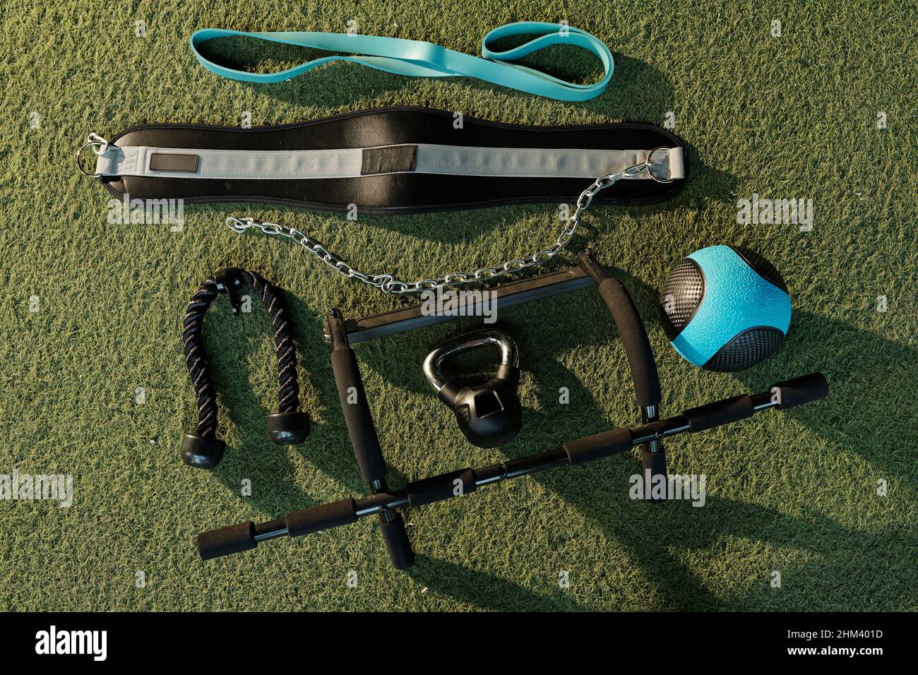 Gym equipment on artificial gym turf including weightlifting belt