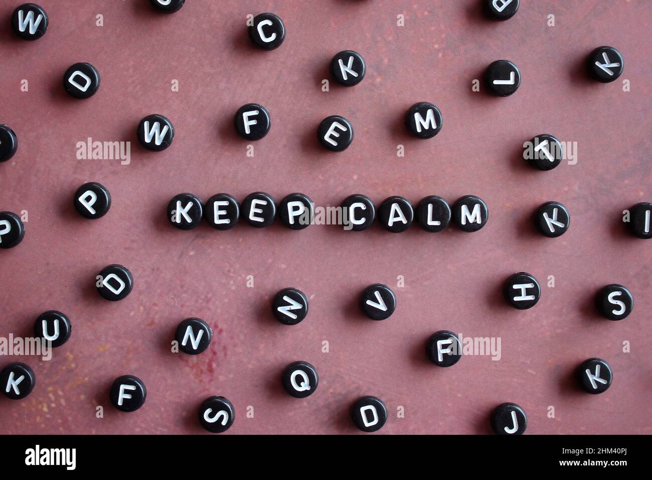 Top view image of alphabet beads with text KEEP CALM. Stock Photo
