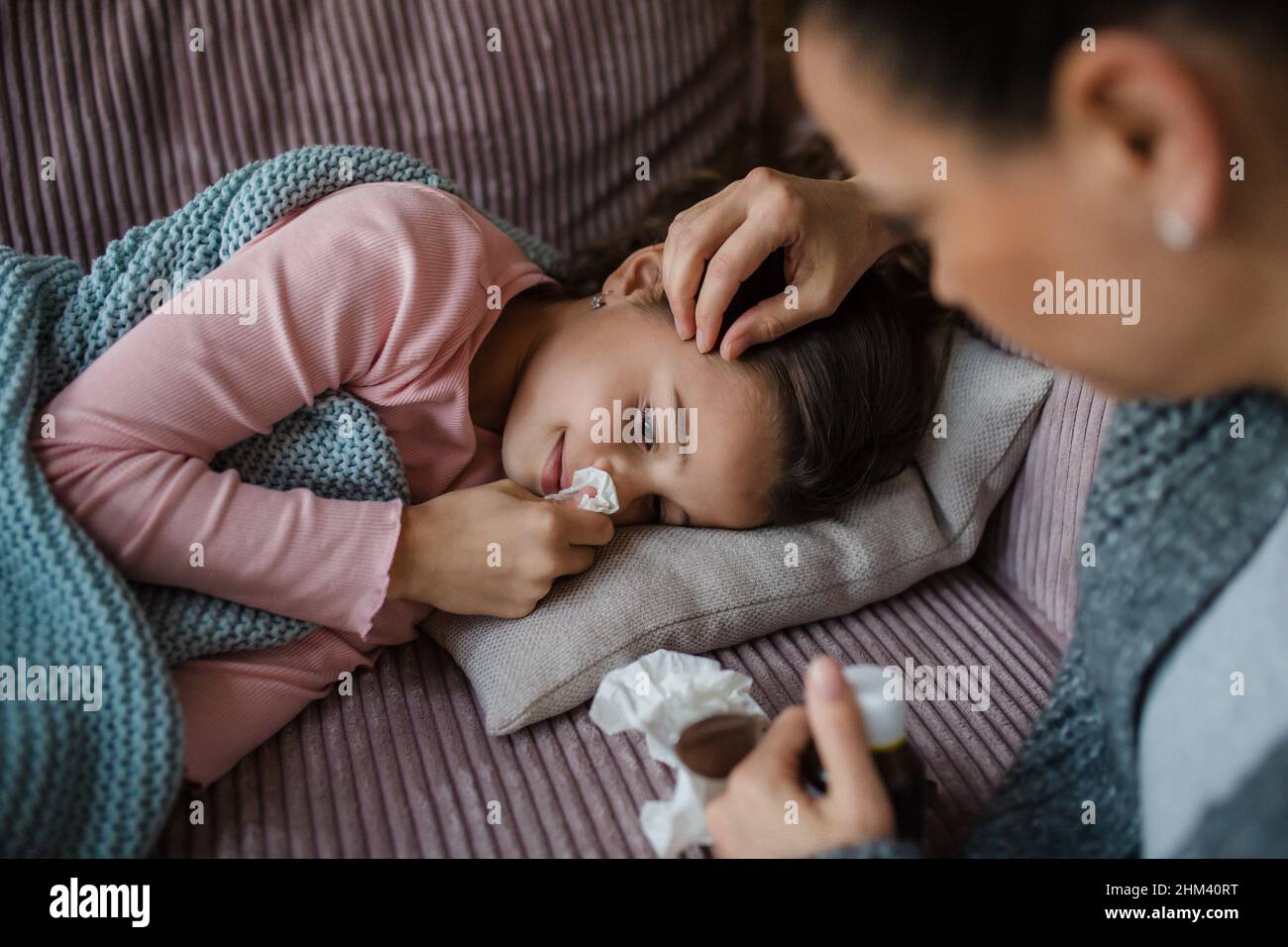 Mother taking care of her sick daughter at home Stock Photo Alamy
