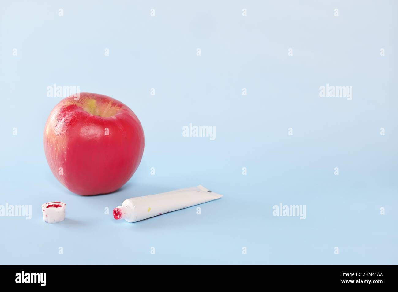 Fake food, coloring, fraud and fraudulent food concept. Apple painted