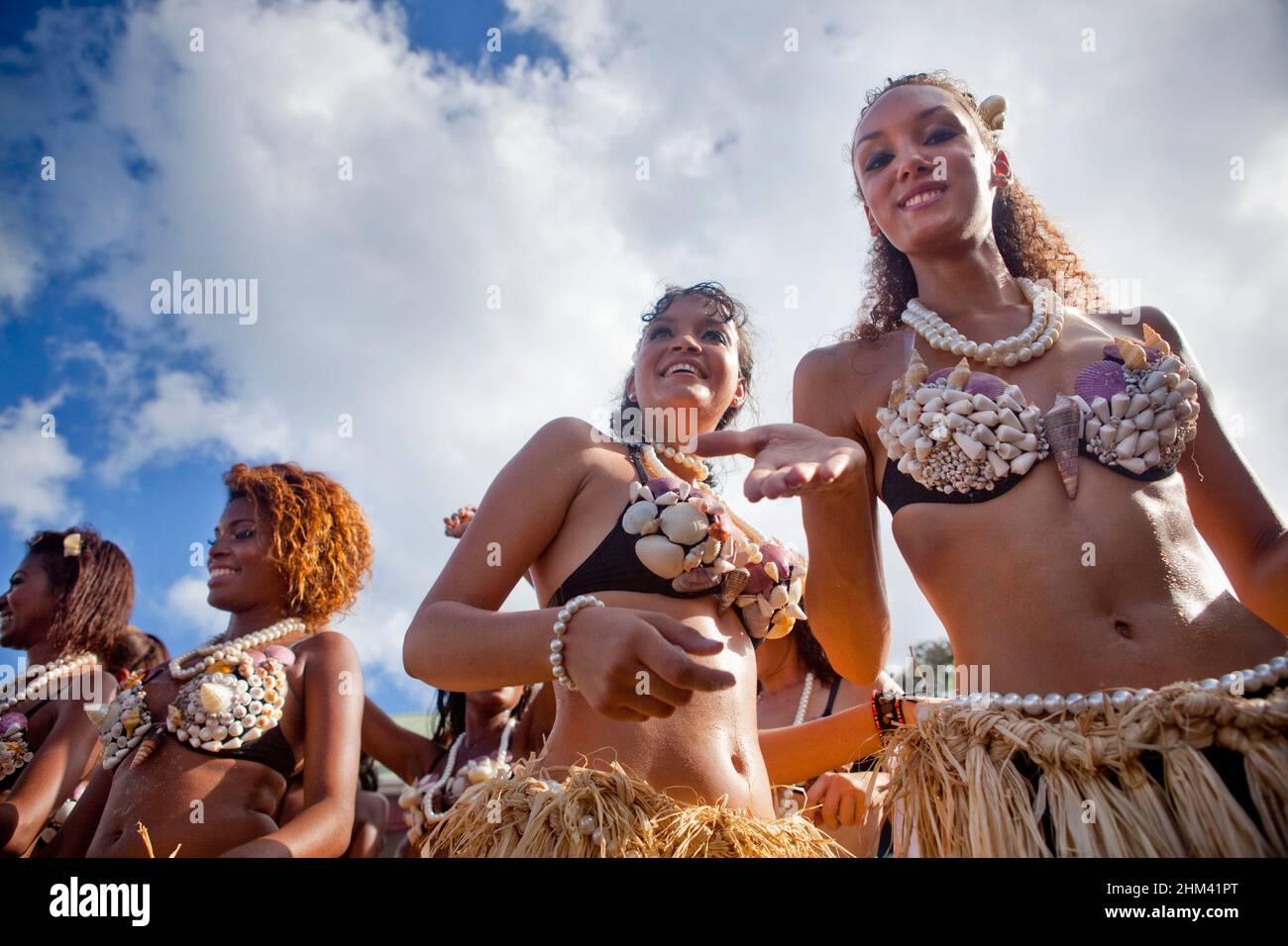 Young women wearing seashells during a street parade at carnival in the Seychelles. Stock Photo