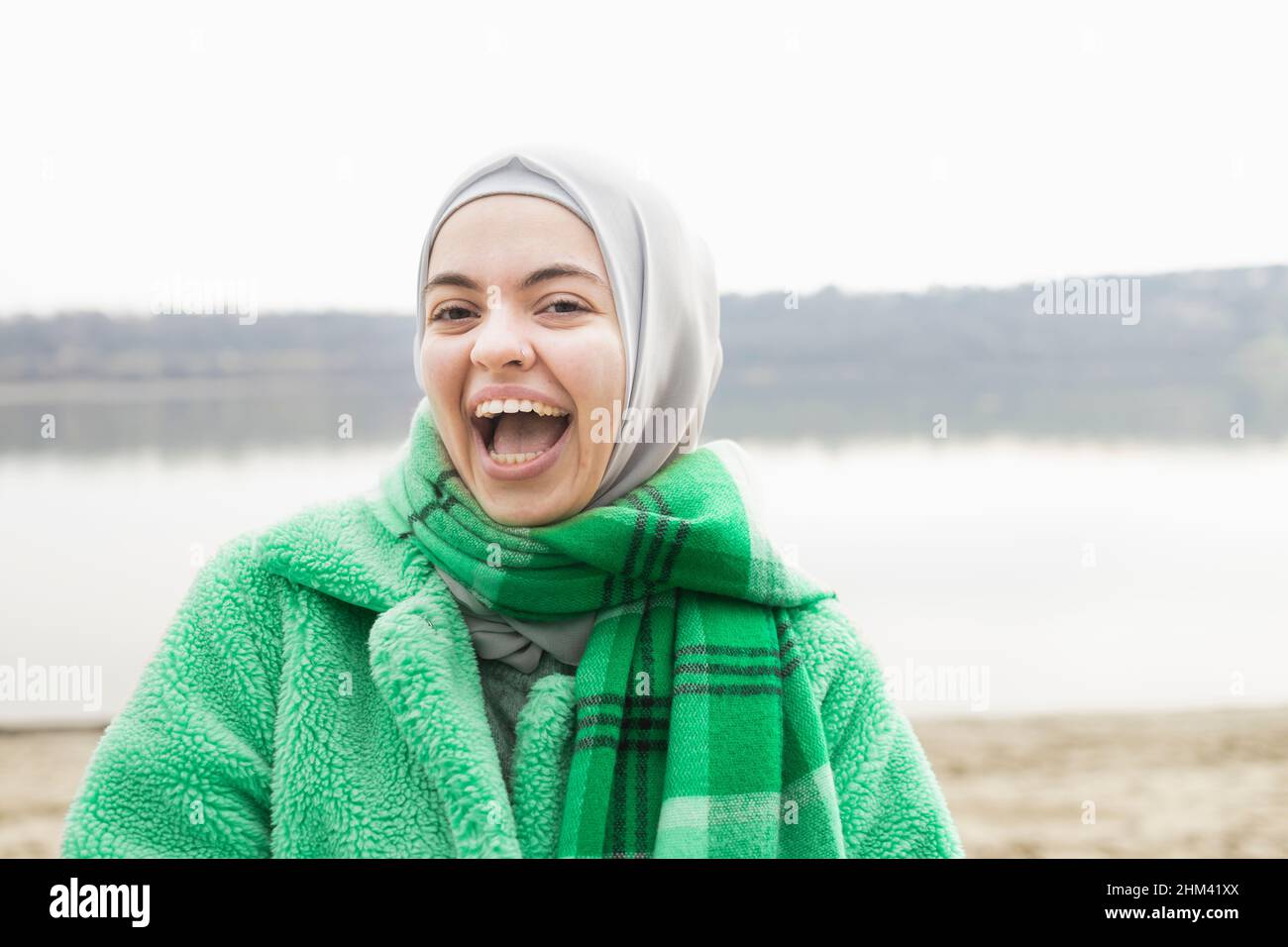 Woman dressed in green smiling wide Stock Photo