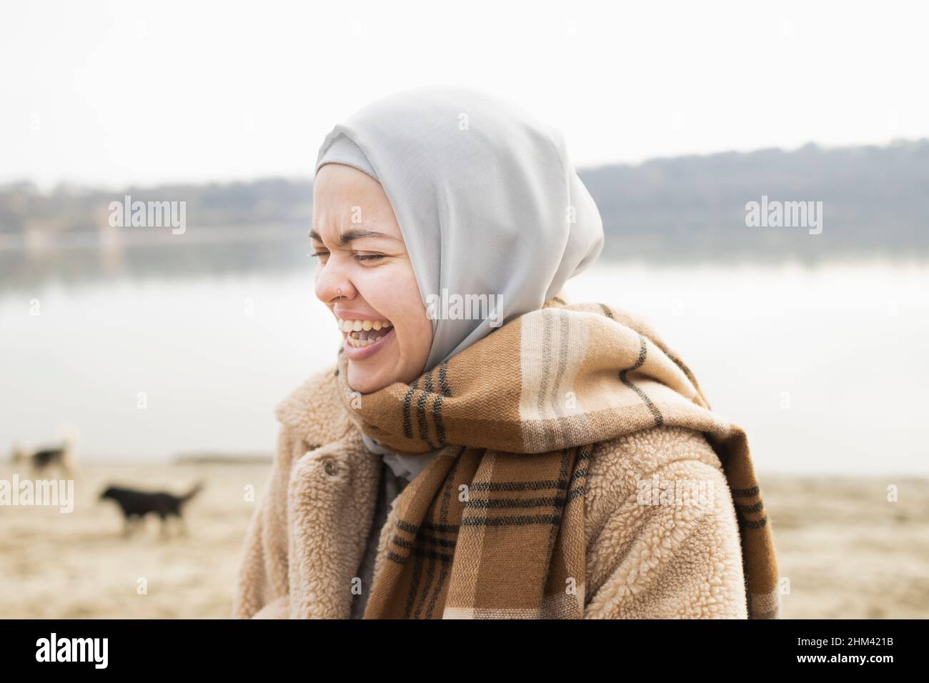 Young woman cannot control herself and looses her to a joke Stock Photo
