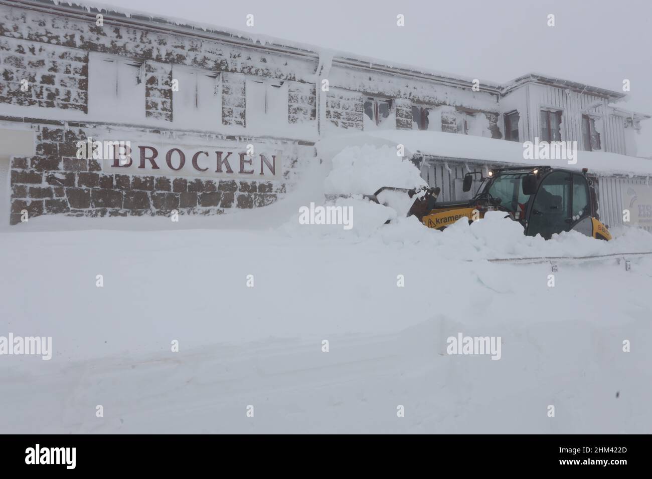 07 February 2022, Saxony-Anhalt, Schierke: A clearing excavator stands at the Brocken train station. Heavy snowfall and storms have caused meter-high snow drifts on the Brocken. Employees of the Brockenwirt and the Harzer Schmalspurbahn are in constant use. Photo: Matthias Bein/dpa-Zentralbild/ZB Stock Photo