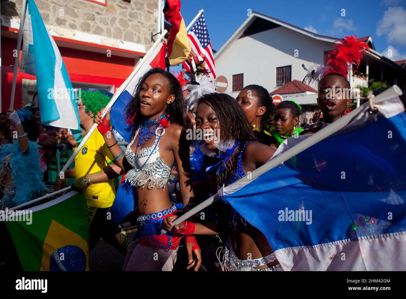 Young women waving flags and celebrating international carnival in the Seychelles. Stock Photo