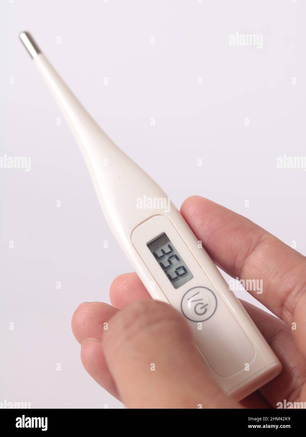 Electronic body thermometer, hand with termometer Stock Photo Alamy