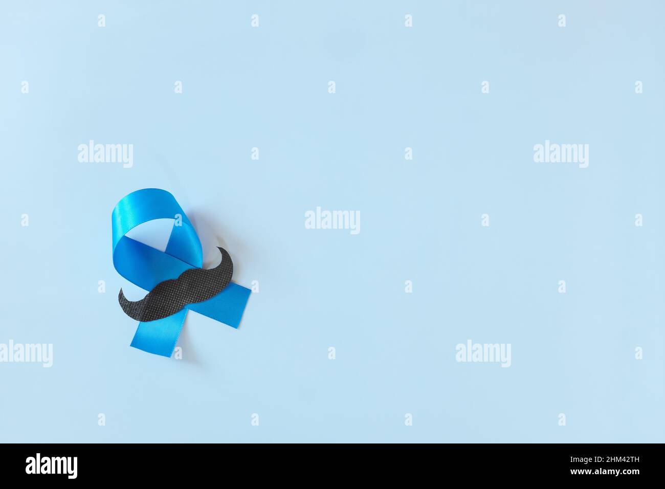 Top view of male hands holding light blue ribbon with mustache. Father ...