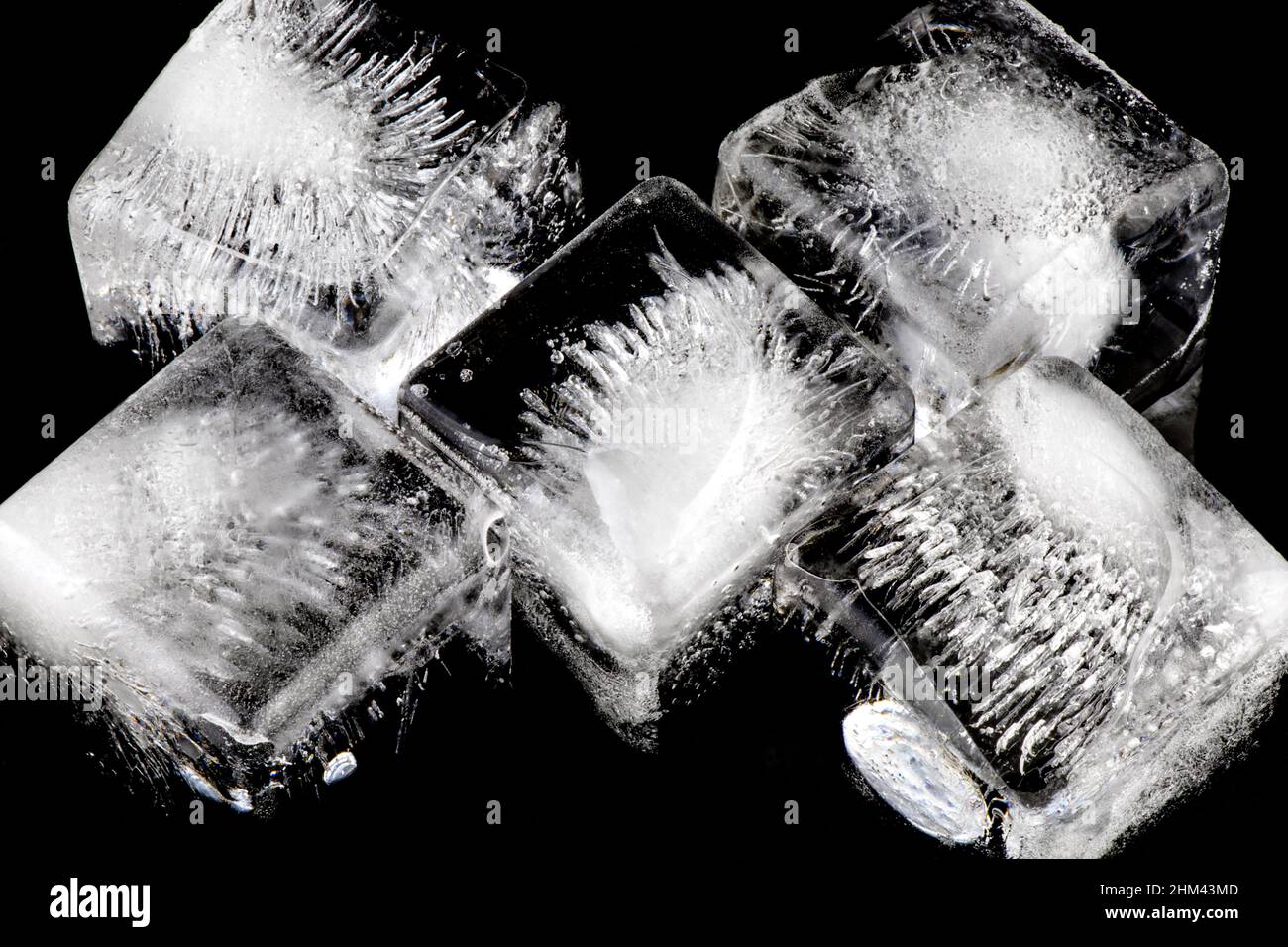 Ice cubes isolated against a black background Stock Photo - Alamy