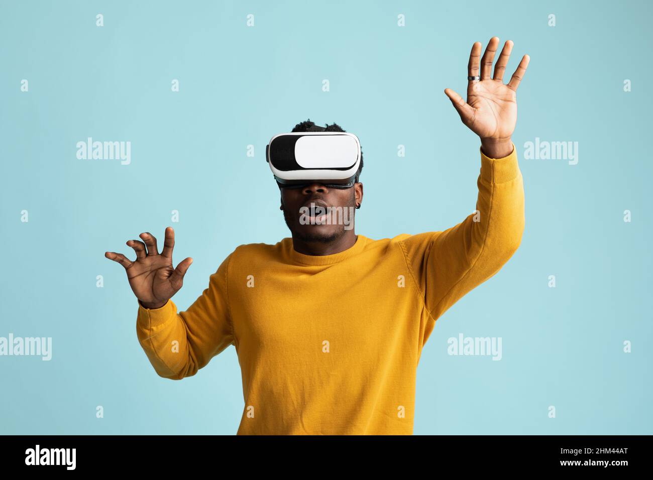 Emotional young african american man using VR glasses Stock Photo - Alamy