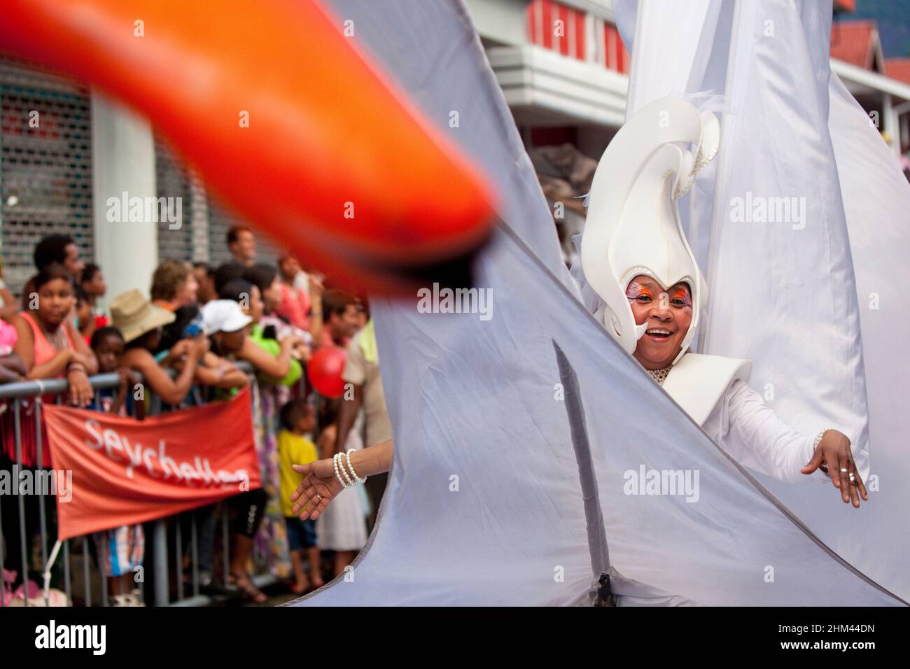 Performer in elaborate swan costume performing in the street during Carnival in the Seychelles. Stock Photo