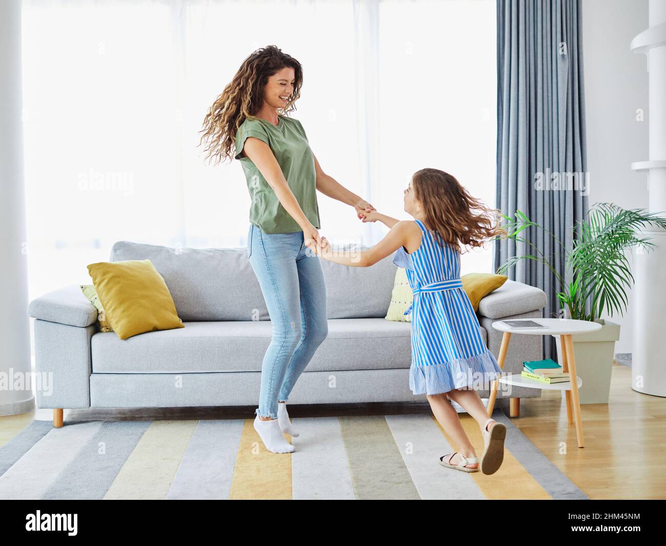 child daughter mother family happy playing kid childhood dancing parent home woman girl Stock Photo