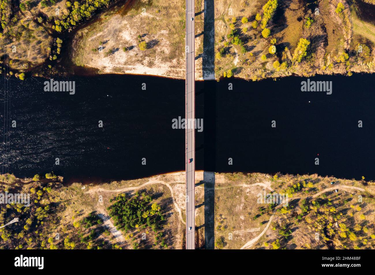 Highway bridge across Pripyat river shot from drone. Countryside rural road and river from above Stock Photo