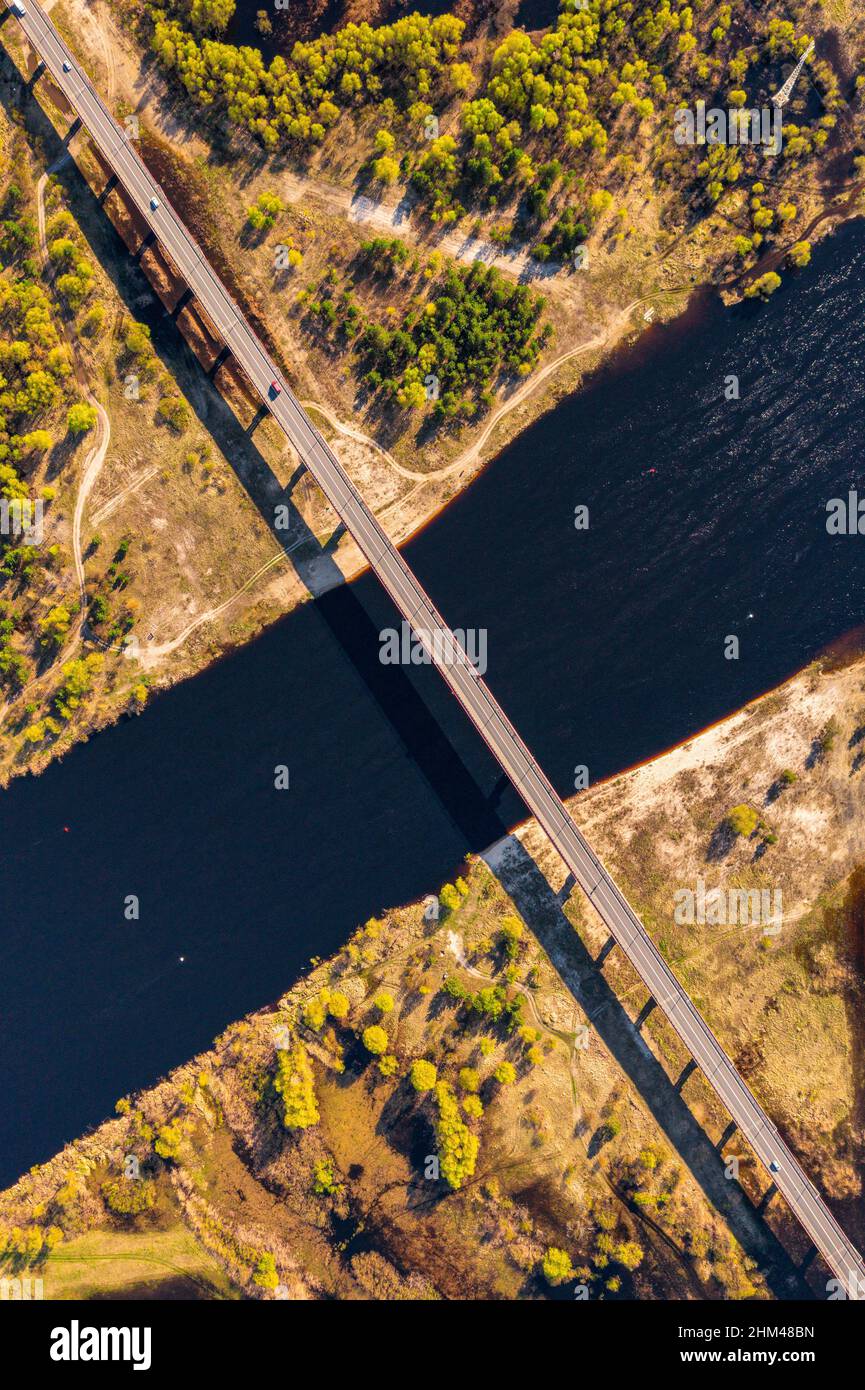 Road bridge crossing river Pripyat from above. Countryside vertical drone photograph Stock Photo