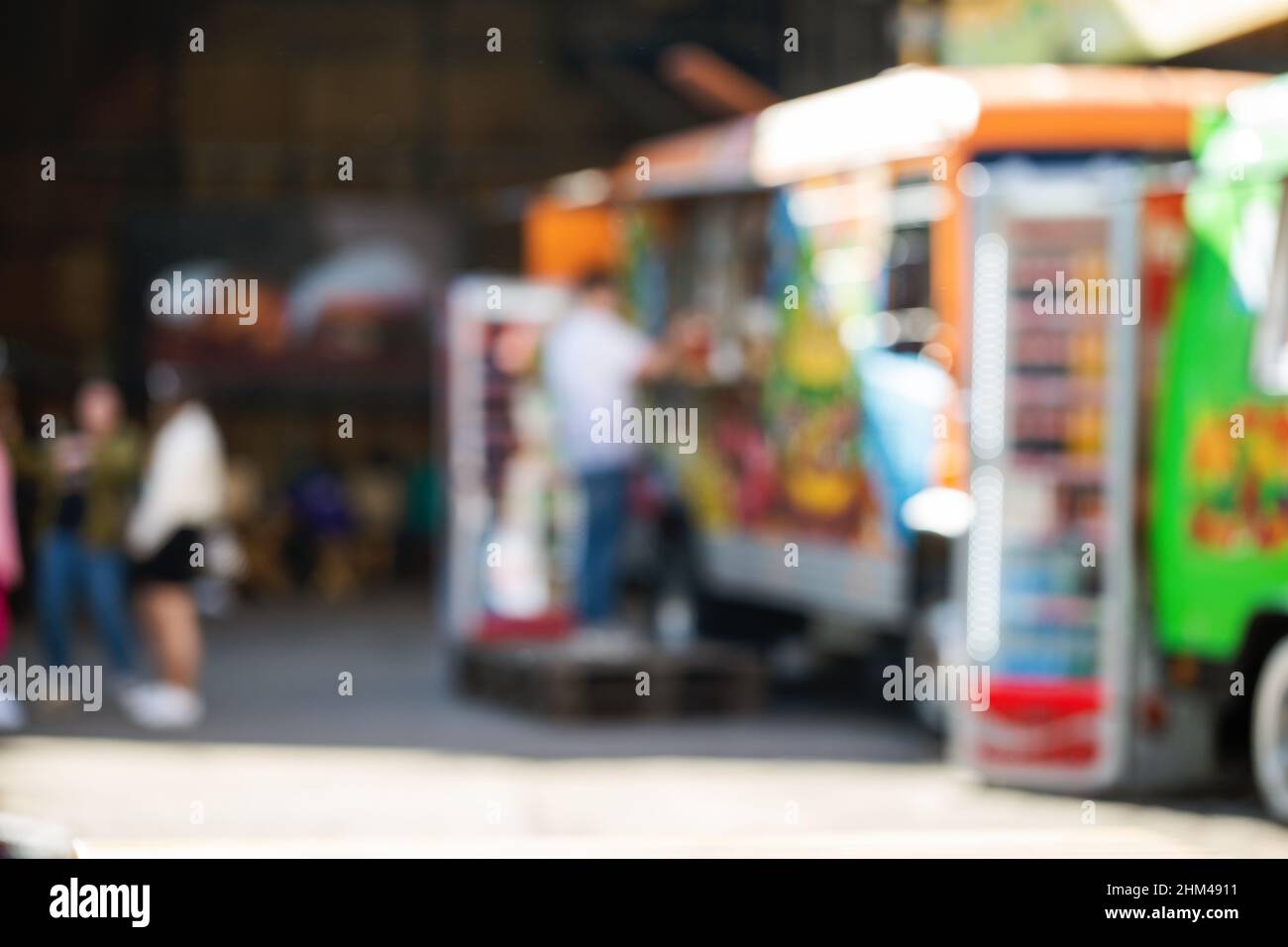 Abstract blurred background of food trucks. People buying food in a foodtruck Stock Photo