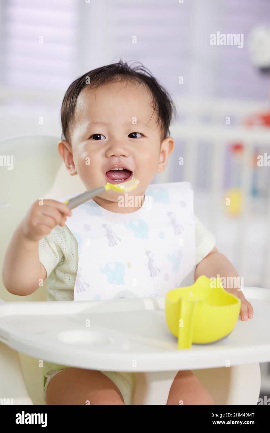 The lovely baby feed itself Stock Photo