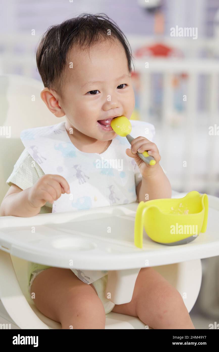 The lovely baby feed itself Stock Photo