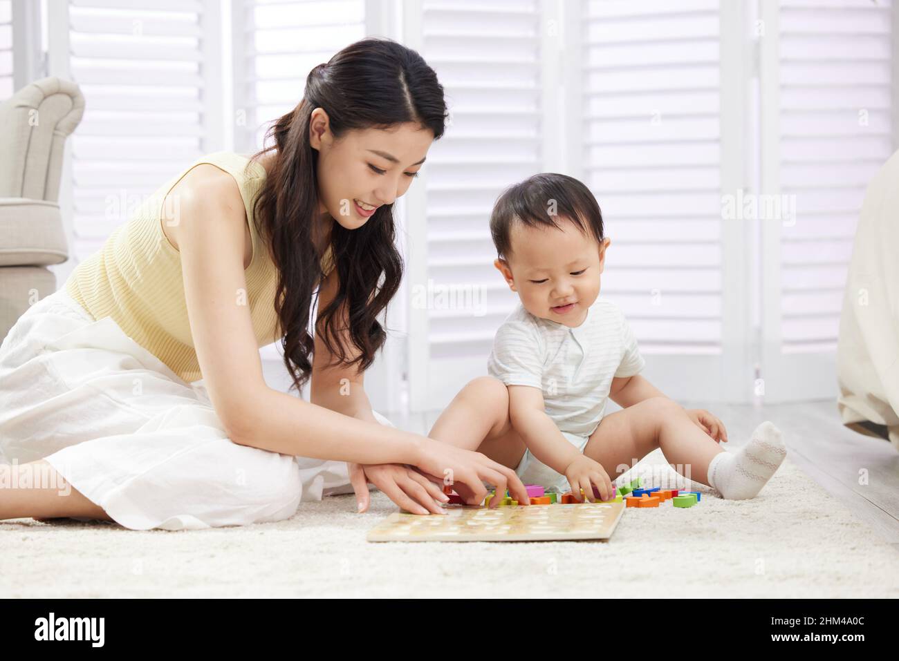 Young mothers play with the baby Stock Photo Alamy