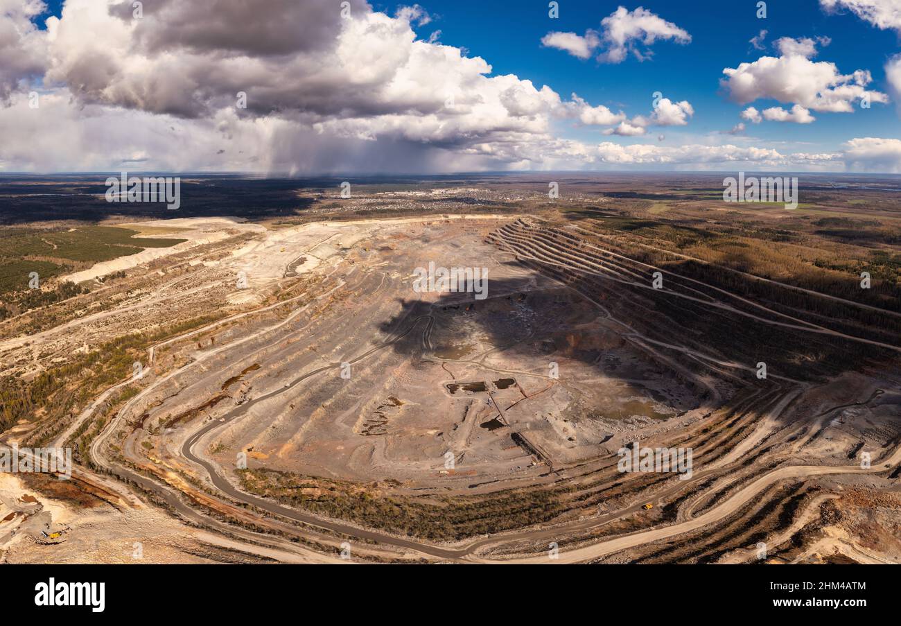 Huge granite quarry in europe aerial view. Panorama on a granite mining facility Stock Photo