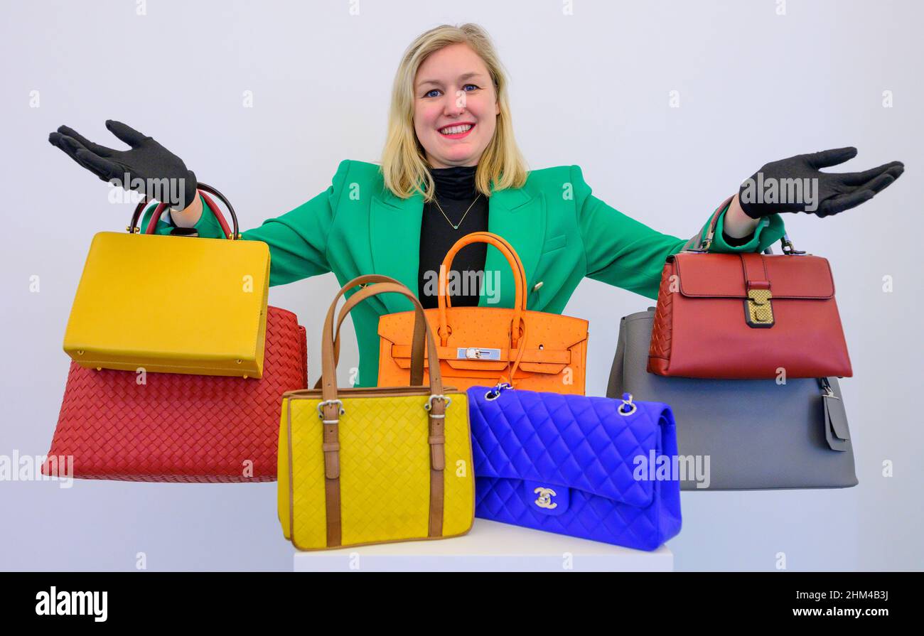 Bonhams, London, UK. 7 February 2022. Fashion sale preview with bags  representing the great houses from Chanel and Hermès to Prada and Gucci.  Image: Among the bags, an Orange H Ostrich Birkin